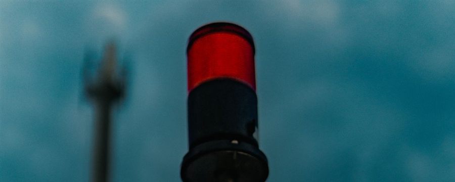 Red signal beacon against a darkening sky