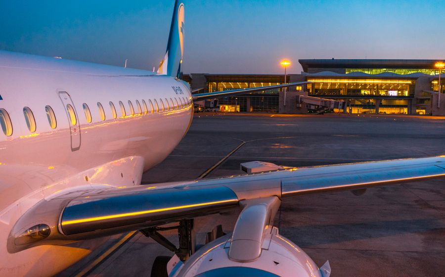 Aircraft parked at an airport terminal at dusk